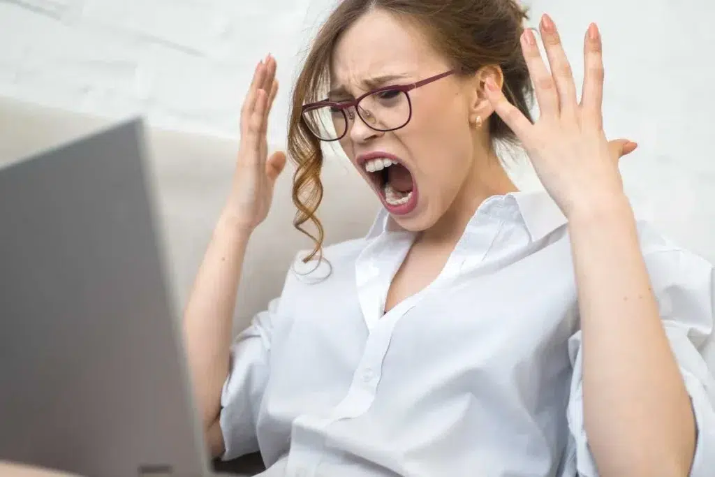 femme criant sur son ordinateur, significateur d'agressivité au travail